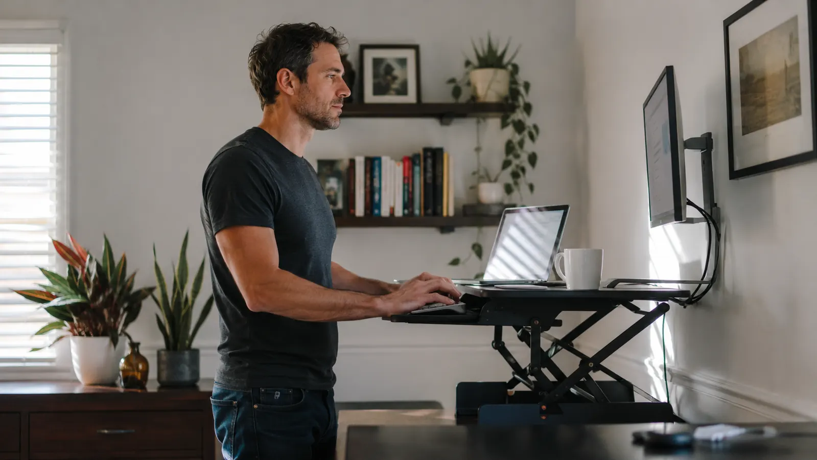 Remote worker standing at a desk converter in a clean, well-lit home office